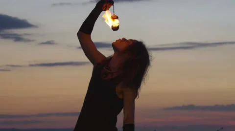 Man puts out fire after performing with fire poi Stock Footage 67628562