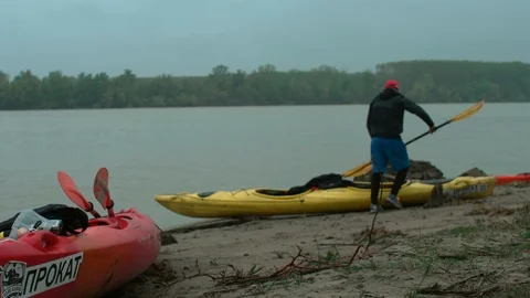 The man puts the paddle in a canoe Stock Footage 109954935