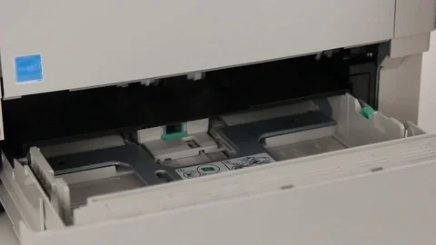 Man puts paper to the printer Stock Footage 69910545