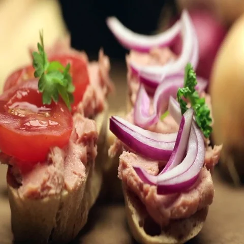 Man puts pate on the bread. Man puts pate with the silver knife on a slice of Stock Footage 69665497