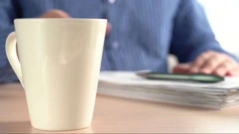 Man Puts A Pen On A Stack Of Papers And Takes A Mug Of Drink. Stock Footage 166502776
