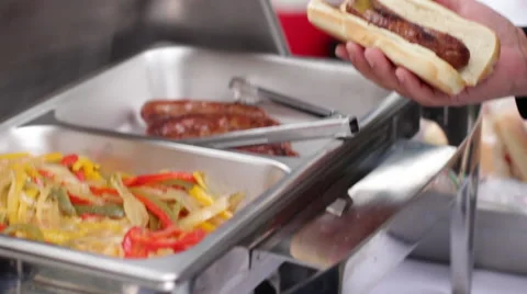 Man Puts Peppers on Bratwurst Stock Footage 61645724