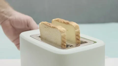 Man puts pieces of bread in toaster, slow motion Stock Footage 271070606
