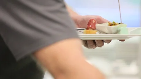 A man puts on a plate snacks Stock Footage 70172899