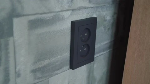 Man puts a plug in the socket Stock Footage 141353762