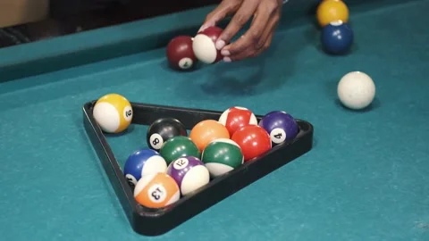 Man puts on the pool table balls in a triangular frame Video stock 156169733