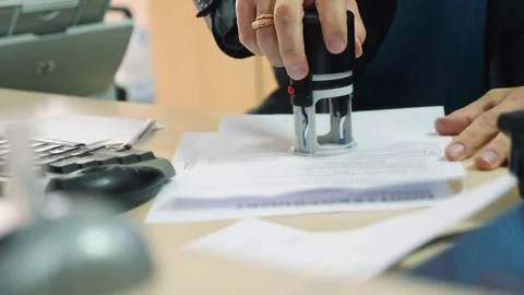 Man puts print stamp on documents Stock Footage 80655151