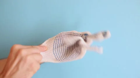 The man puts on protective construction gloves. Gloves made from durable fabric Stock Footage 159151575
