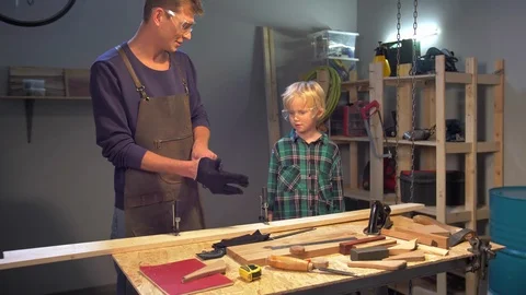 Man puts on protective gloves in the workshop Stock Footage 126712296