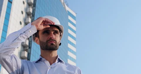 Man puts on protective helmet Stockbeeldmateriaal 160555171