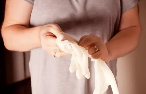 Man puts on protective rubber gloves. Protection against contagious disease a Stock Photos