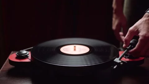 Man puts a record on a vinyl player. dark room. close-up. Stock Footage 212606815