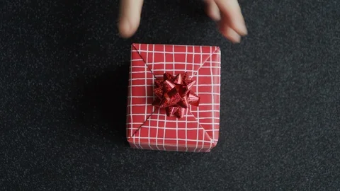 Man puts Red gift box isolated on black background. Xmas, Valentines, Birthday. 스톡 동영상 121248243