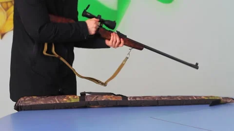 A man puts a rifle in a special protective case Stock Footage 237797750