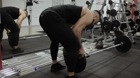 Man puts the ring on the rod in the gym Stock Footage 56636944