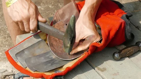 A man puts a rivet on plate armor 스톡 동영상 123583701