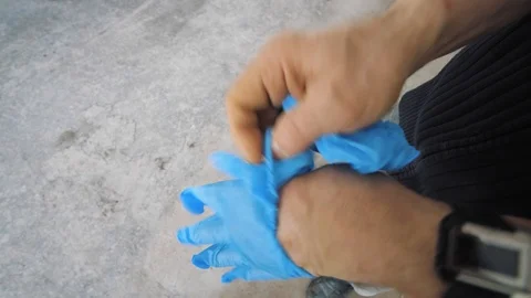 Man puts on rubber gloves Stock Footage 127530657