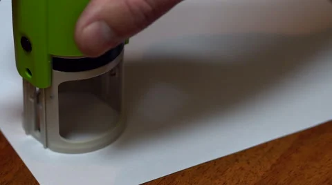 A man puts a seal on a document Stock Footage 68835029