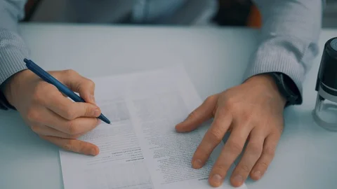 The man puts a seal on the document Stock Footage 129168806