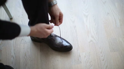 The man puts shoes on. Stock Footage 46178565