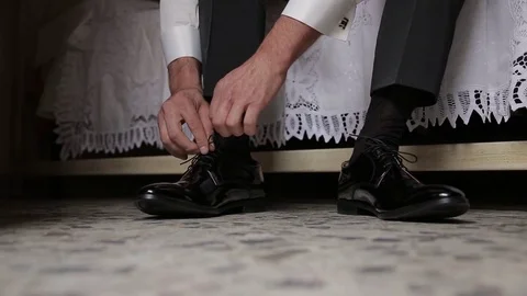 Man puts on shoes. Wedding Video stock 72354020