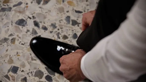 Man puts on shoes. Wedding Video stock 72354036