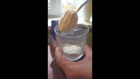 Man puts some flour into a glass , close-up vertical video Stock Footage 292884824
