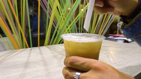 Man puts a straw in a bubble tea cup 스톡 동영상 138648429