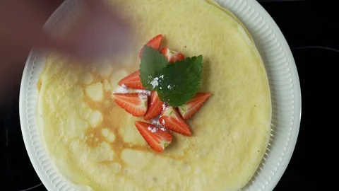 Man puts strawberries on pancakes Stock Footage 79118812
