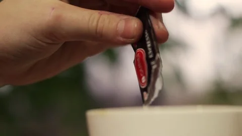 Man puts sugar in a cup of coffee Stock Footage 71989448
