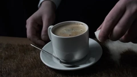 Man puts sugar in a cup of coffee Vidéo 168816229