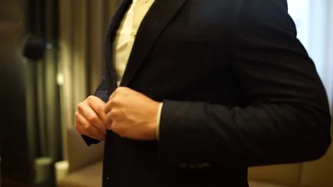 Man puts on a suit Stock Footage 125333293