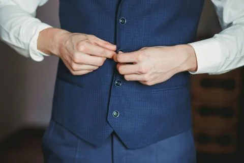 Man puts on a suit Stock Photos