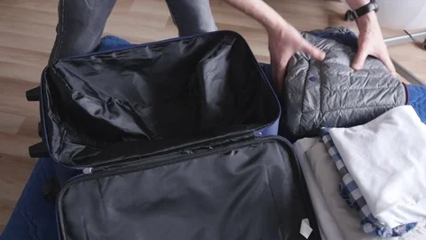 Man puts the suitcase on the bed Stock-Footage 75205745