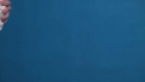 Man puts on table plaster bust of Antinous, who has new medical mask on his face Stock Footage 162542976