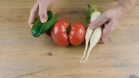 Man puts on the table ugly vegetables Stock Footage 169295926
