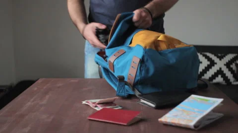 Man puts things in a backpack Vídeo Stock 64475161
