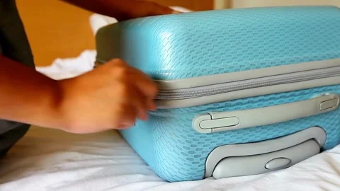 A man puts things in a suitcase. Preparation for a trip or journey. packing Stock Footage 336235776