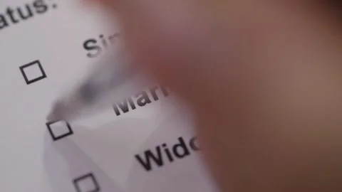 A man puts a tick in front of the word Married in the test Stock Footage 145630157