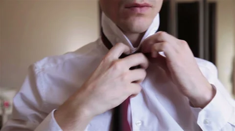 Man puts on a tie Stock Footage 60049977