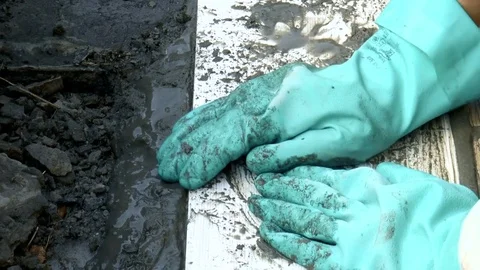 Man puts the tile on the cement grout Stock Footage 79540106