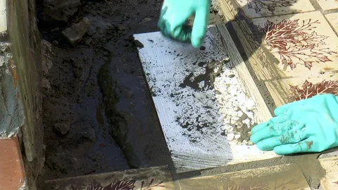 Man puts the tile on the cement grout Stock Footage 79848330