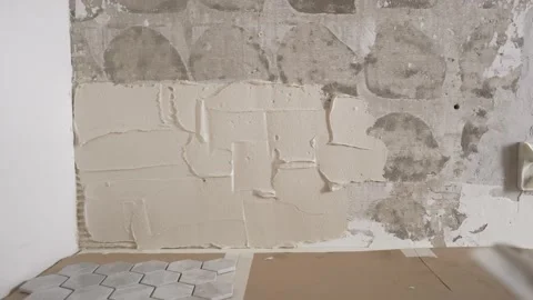 A man puts tiles on the wall. Stock Footage 233342995