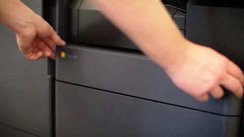 Man puts toner in the printer YCMK Stock Footage 74009134