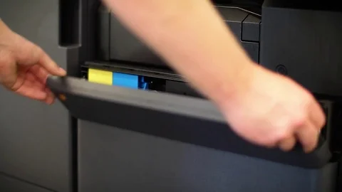 Man puts toner in the printer YCMK Stock Footage 74011958