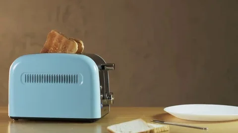 Man Puts Two Loaves of Bread Into an Electric Toaster Stock Footage 69174379