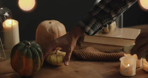 Man puts two pumpkins on the table Stock Footage 140822963