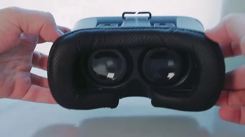 Man Puts Virtual Reality Glasses on Table Stock Footage 74081697