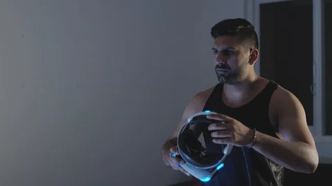 Man Puts Virtual Reality Goggles on, Ready to Play Video Game, Night Stock Footage 108880702