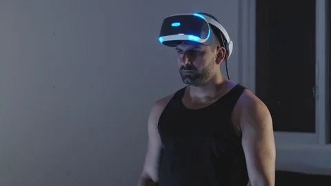 Man Puts Virtual Reality Goggles on, Ready to Play Video Game, Night Stock Footage 108881779